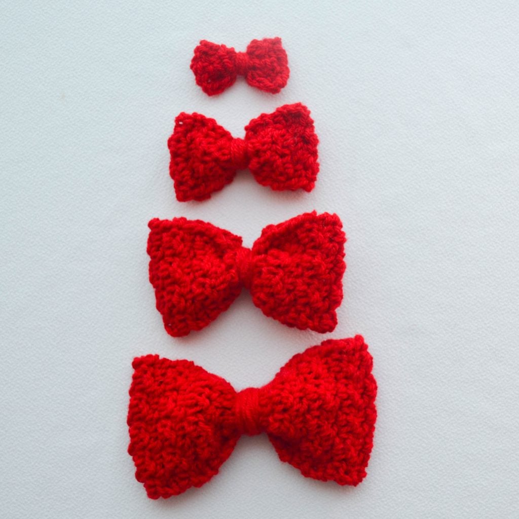 Image of four different crochet bows laid on a flat surface