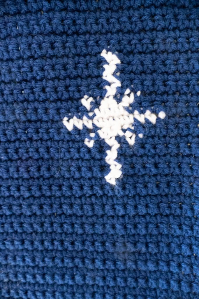 close shot of the crochet star in this wall hanging