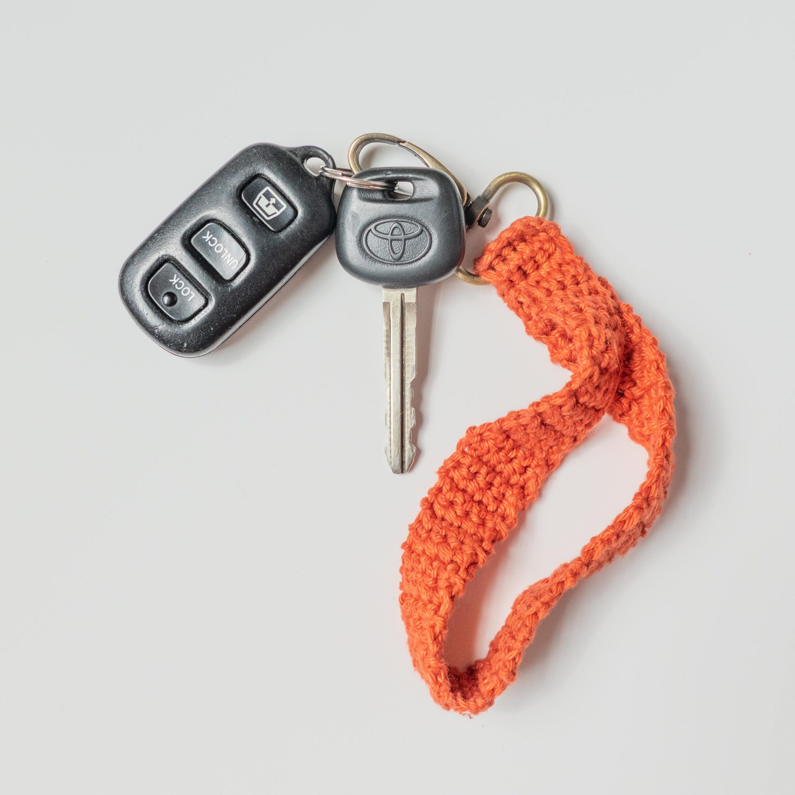 Flat lay of a red crochet key strap