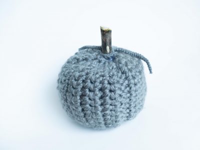 Small gray crochet pumpkin with wooden stem