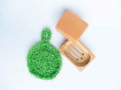green crochet scrubbie with soap and wooden holder