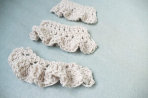 Three swatch of crocheting ruffles with different types of yarn