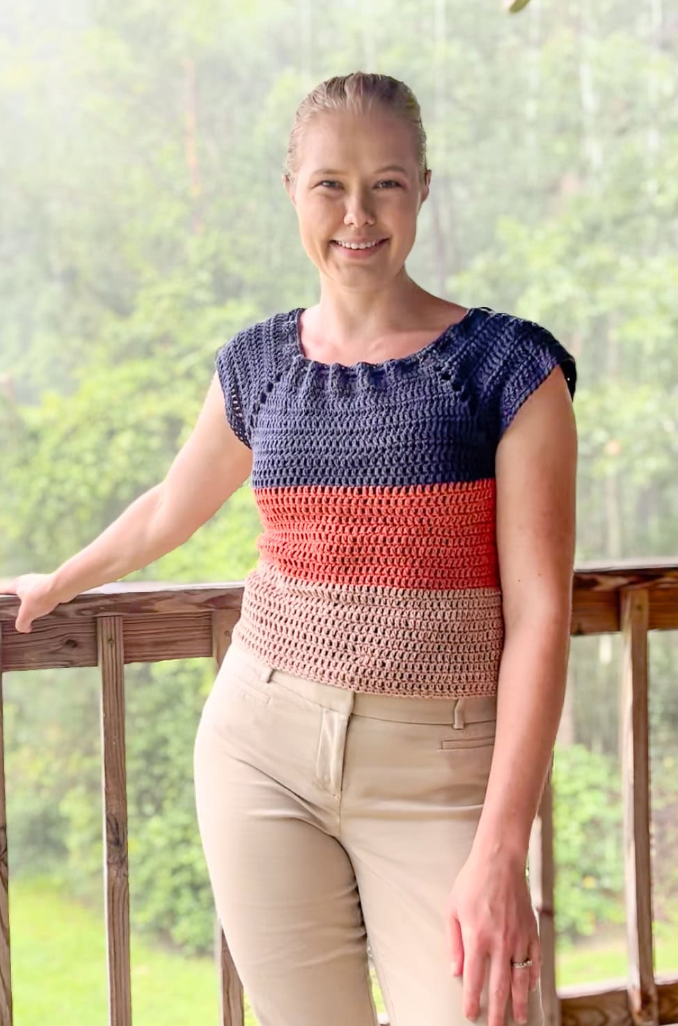 Modeling a crochet stripped top and smiling