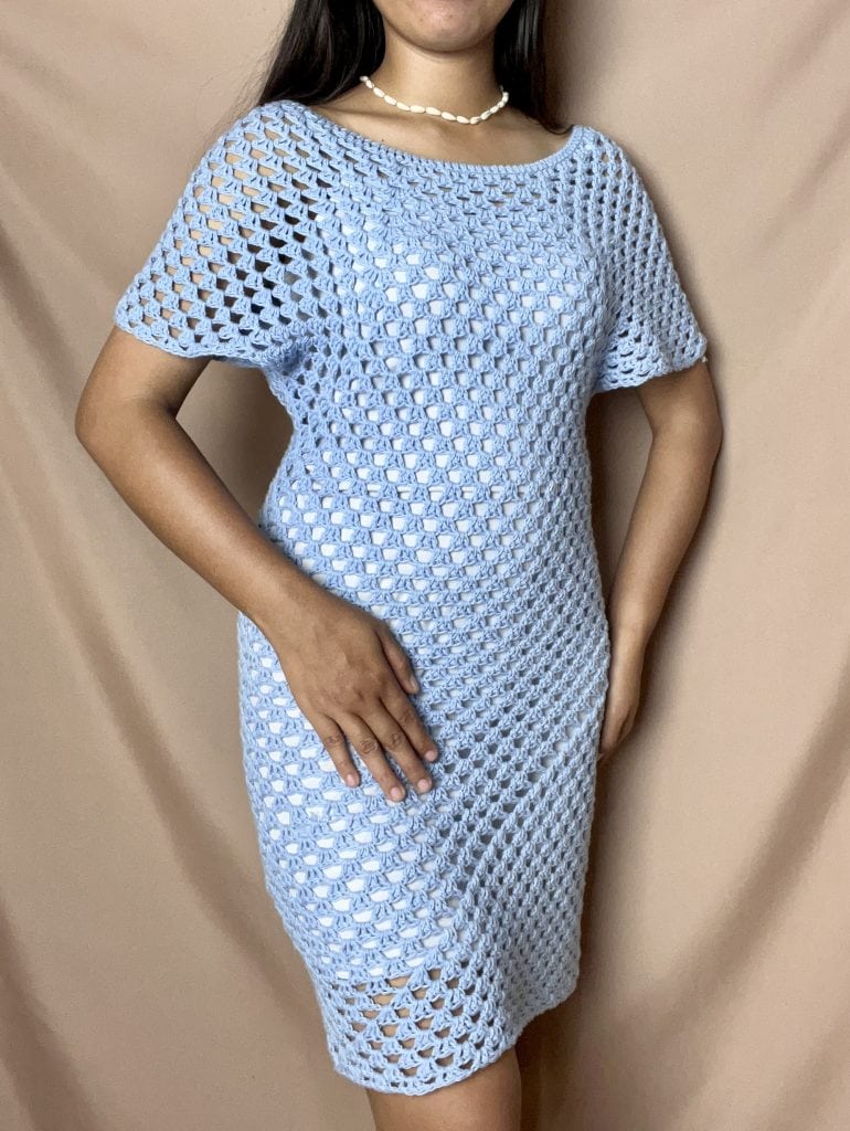 A blue granny stitch short crochet dress being modeled